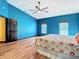 Bright bedroom featuring wood flooring, a ceiling fan, and large windows at 364 Terrace Rd, Tarpon Springs, FL 34689