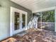 Screened porch with access to backyard and tiled floors at 364 Terrace Rd, Tarpon Springs, FL 34689