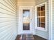 Front door entry with a glass door and a welcome mat at 364 Terrace Rd, Tarpon Springs, FL 34689