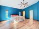 Sunlit bedroom with blue walls, wood flooring, and a ceiling fan at 364 Terrace Rd, Tarpon Springs, FL 34689