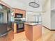 Modern kitchen with wood cabinets, granite island, and black appliances at 364 Terrace Rd, Tarpon Springs, FL 34689