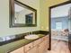 Main bathroom with granite countertop, double sink vanity, and a view of the bedroom at 364 Terrace Rd, Tarpon Springs, FL 34689