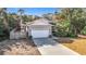 Single-story house with a two-car garage and landscaped yard at 364 Terrace Rd, Tarpon Springs, FL 34689