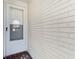 White front door with a window and brick flooring at 4220 Sheldon Pl # 4220, New Port Richey, FL 34652