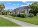 White building with gray roof and landscaping, in a residential neighborhood at 4220 Sheldon Pl # 4220, New Port Richey, FL 34652