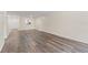 Living room showcasing wood-look floors and views of kitchen at 4220 Sheldon Pl # 4220, New Port Richey, FL 34652