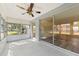 Bright sunroom with sliding glass doors leading to backyard and ceiling fan at 4220 Sheldon Pl # 4220, New Port Richey, FL 34652