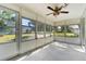 Bright screened porch with view of backyard and ceiling fan at 4220 Sheldon Pl # 4220, New Port Richey, FL 34652