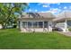 House exterior with a screened porch and landscaped lawn at 4220 Sheldon Pl # 4220, New Port Richey, FL 34652