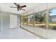 Bright enclosed porch with a ceiling fan and view of the backyard at 4220 Sheldon Pl # 4220, New Port Richey, FL 34652