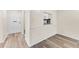 View of entryway with white door and a glimpse of the kitchen at 4220 Sheldon Pl # 4220, New Port Richey, FL 34652