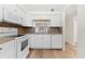 White kitchen with granite countertops and modern appliances at 4220 Sheldon Pl # 4220, New Port Richey, FL 34652