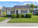 Cute bungalow style home with gray roof and well-maintained landscaping at 4220 Sheldon Pl # 4220, New Port Richey, FL 34652