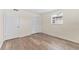 Bedroom with wood-look floors, a door and double closet at 4220 Sheldon Pl # 4220, New Port Richey, FL 34652