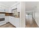 White kitchen cabinets, tile backsplash, and modern appliances at 4220 Sheldon Pl # 4220, New Port Richey, FL 34652