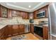 Modern kitchen with stainless steel appliances and wood cabinets at 5200 Brittany S Dr # 1708, St Petersburg, FL 33715