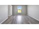 Bright bedroom with wood-look floors and a large window at 6731 Wirevine Dr, Brooksville, FL 34602