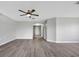 Living room with hardwood floors and access to hallway at 6731 Wirevine Dr, Brooksville, FL 34602