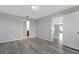 Spacious bedroom with wood-look floors and access to bathroom and living room at 6731 Wirevine Dr, Brooksville, FL 34602