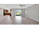 Spacious living room with vinyl plank flooring and access to the back patio at 6731 Wirevine Dr, Brooksville, FL 34602