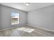 Bright bedroom with wood-look floors and window at 6731 Wirevine Dr, Brooksville, FL 34602
