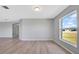 Spacious living room featuring wood-look floors and a large window at 6731 Wirevine Dr, Brooksville, FL 34602