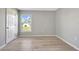 Bright bedroom featuring wood-look floors and window at 6731 Wirevine Dr, Brooksville, FL 34602