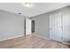 Well-lit bedroom with wood-look floors and window at 6731 Wirevine Dr, Brooksville, FL 34602
