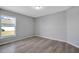 Simple bedroom with wood-look floors and window at 6731 Wirevine Dr, Brooksville, FL 34602