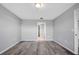 Spacious bedroom with wood-look floors and access to bathroom at 6731 Wirevine Dr, Brooksville, FL 34602