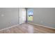 Spacious bedroom with wood-look floors and window at 6731 Wirevine Dr, Brooksville, FL 34602