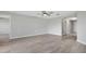 Open living area with hardwood floors, neutral walls, and hallway access at 6731 Wirevine Dr, Brooksville, FL 34602