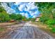 Long driveway leading to a home nestled among lush greenery at 7923 18Th E Ave, Palmetto, FL 34221