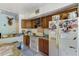A galley-style kitchen with wood cabinets and appliances at 7923 18Th E Ave, Palmetto, FL 34221