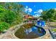 Kidney-shaped pool reflecting the sky, near a dome house at 7923 18Th E Ave, Palmetto, FL 34221