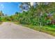 Residential street view with lush landscaping at 7923 18Th E Ave, Palmetto, FL 34221