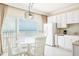 Kitchen with ocean view, white cabinets, and a round dining table at 9980 Gulf Blvd # 614, St Petersburg, FL 33706