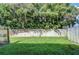 Exterior yard with mature trees and a tall wooden fence at 10100 Sailwinds N Blvd # 106, Largo, FL 33773