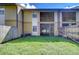 Private backyard with grass and wooden fence at 10100 Sailwinds N Blvd # 106, Largo, FL 33773