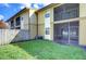 Green grassy backyard with wooden fence at 10100 Sailwinds N Blvd # 106, Largo, FL 33773