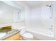 Bathroom with large mirror, vanity, and shower-tub combo with tiled walls at 10100 Sailwinds N Blvd # 106, Largo, FL 33773