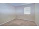 Cozy bedroom with neutral carpet, ample lighting, and a large window at 10100 Sailwinds N Blvd # 106, Largo, FL 33773