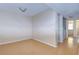 A vacant bedroom with bamboo flooring and an adjoining laundry room at 10100 Sailwinds N Blvd # 106, Largo, FL 33773