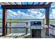 Outdoor kitchen on dock featuring a stainless steel grill with stunning water views at 10100 Sailwinds N Blvd # 106, Largo, FL 33773