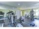 Bright community gym featuring an elliptical, treadmill, rowing machine, and weight-lifting machine at 10100 Sailwinds N Blvd # 106, Largo, FL 33773