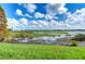 Scenic lake views, featuring lush green grass at 10100 Sailwinds N Blvd # 106, Largo, FL 33773