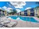 Community pool with lounge chairs and well-maintained landscaping at 10100 Sailwinds N Blvd # 106, Largo, FL 33773