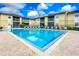Community pool with lounge chairs and a relaxing atmosphere at 10100 Sailwinds N Blvd # 106, Largo, FL 33773