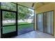 Screened back porch with view of backyard, ceiling fan, and exterior light at 10100 Sailwinds N Blvd # 106, Largo, FL 33773