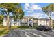 Two-story condo building with parking and landscaping at 1127 Pine Ridge W Cir # A2, Tarpon Springs, FL 34688